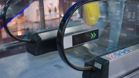 Man Stepping Onto Moving Escalator With Arrow Sign In Mall Stock Footage 319918943