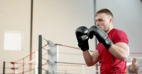 Man stepping into ring delivering punches at punching bag for training, copy Stock Footage 341942721