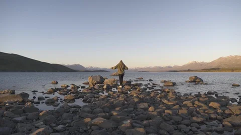 Man stepping on the rocks and reaching the river coast Stock Footage 95008399