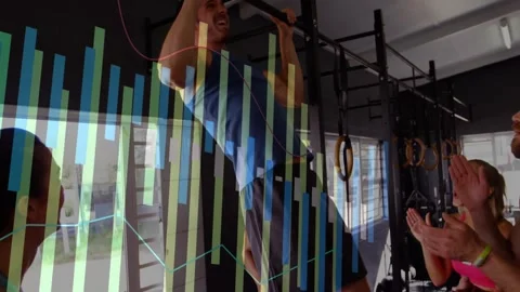 Man stepping under gym pull-up bar and gripping while friends cheering for Stock Footage 326425519