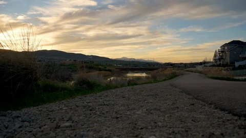 Man steps off the path to admire  stunning sunset Stock Footage 106738480