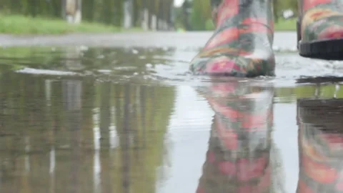 Man steps into a puddle during the rain Stock Footage 235170909