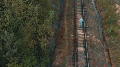 A man steps on a rail in the forest Stock Footage 130845246