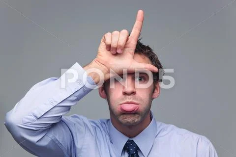 Man sticking his tongue out and gesturing loser Stock Photos