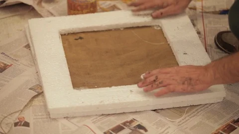 A man sticks frames on the cloth Stock Footage 86810029