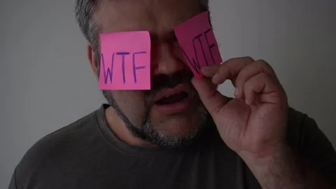 Man with sticky notes on eyes. worker male wears  stickers. wtf -  inscription. Stock Footage 238526225