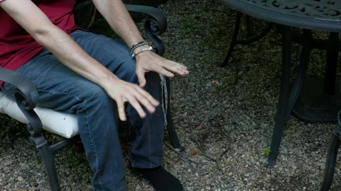 Man Stimming with Rhythmic Hand Tapping on Knees Stock Footage 337911714
