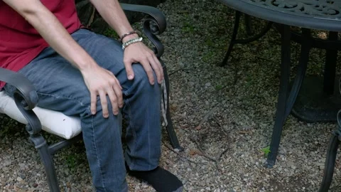 Man Stimming with Rhythmic Hand Tapping on Knees Stock Footage 337911720