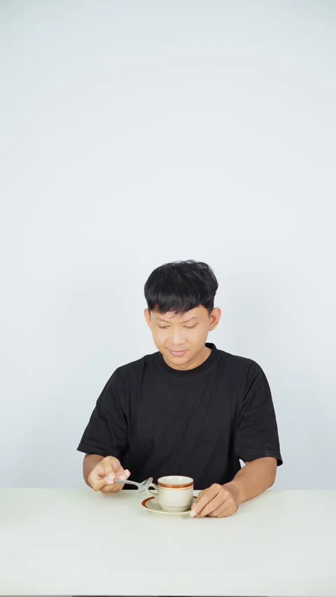 Man Stirring and Drinking Coffee on White Background Stock-Footage 347105217