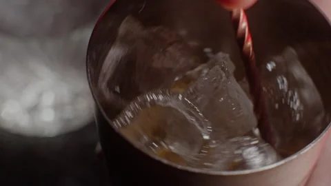 Man stirring a cocktail on ice Stock Footage 255703171