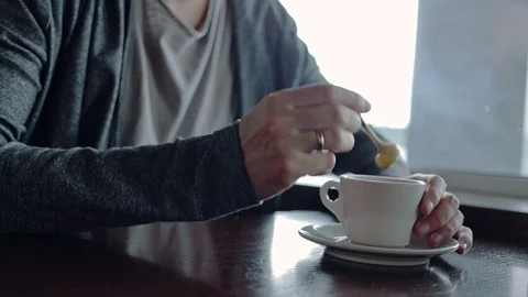 Man stirring coffee at restaurant Stock Footage 91556495