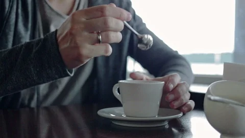 Man stirring coffee at restaurant Stock Footage 91556531