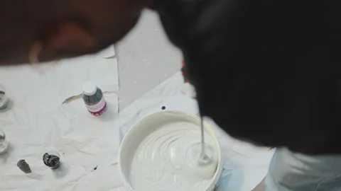 Man Stirring Paint in Bucket with Drill for Renovating Home Stock Footage 269742941