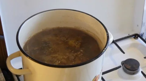Man Stirring the Soup by Spoon Stock Footage 42563731