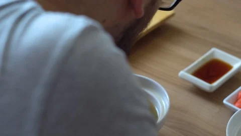The man stirs and eats miso soup closeup 4K Stock Footage 96886013