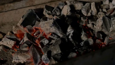 Man stirs coals in the grill Video stock 80043395