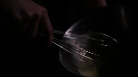 Man stirs eggs in the plate in the dark Stock Footage 61786162