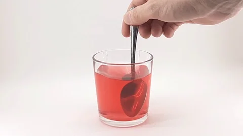 Man stirs red water Stock Footage 124830760