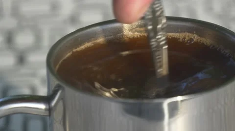 Man stirs sugar in coffee Stock Footage 66438463