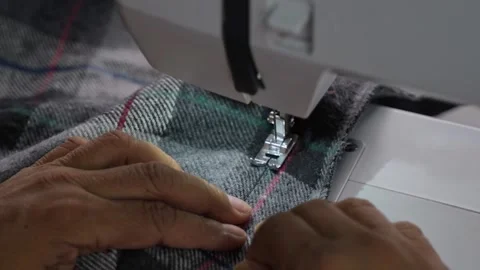 Man Stitching Clothes Using an Electric Sewing Machine Stock Footage 343375656
