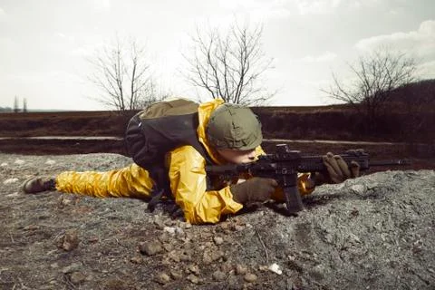 Man in stocking mask afraid of nuclear attack in landscape ready to fight Stock Photos