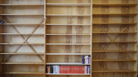 Man stocks bookshelf Stock Footage 43410170