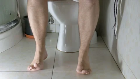 A man with stomach problems and diarrhea runs to the toilet Stock Footage 271235426