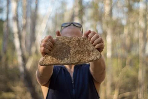 Man with a stone Stock-Fotos