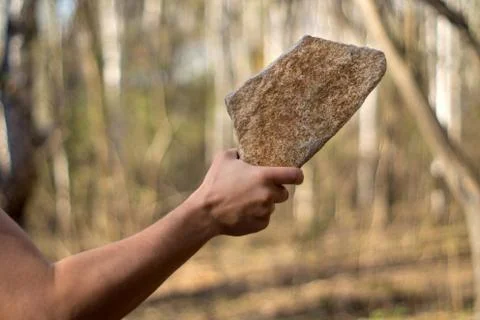 Man with a stone 写真素材