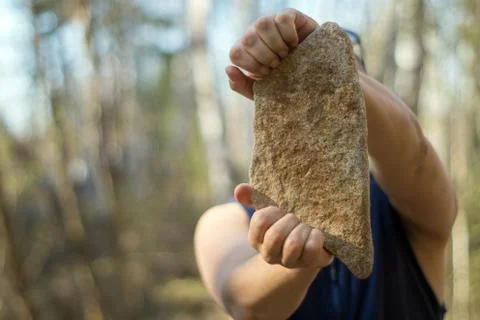 Man with a stone Foto stock