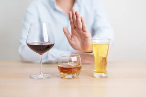 Man stop hand gesture to refuse a glass of wine, beer, whiskey or cognac on.. Stock Photos