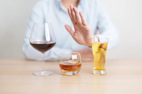 Man stop hand gesture to refuse a glass of wine, beer, whiskey or cognac on.. Stock Photos