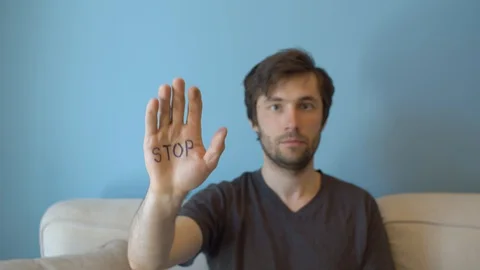 Man with stop sign on the hand Stock Footage 129350387