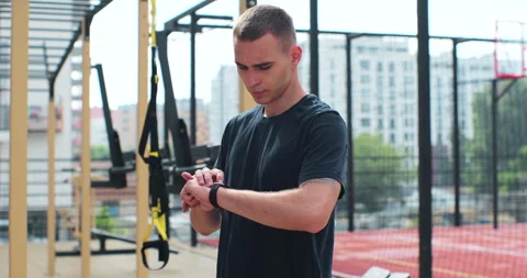 Man stopped workout to check indicators on her fitness watch. Healthy lifestyle Stock Footage 246366749