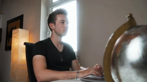 Man stops to work and thinks about a decision while scratching his face, 4K Stock Footage 129612999