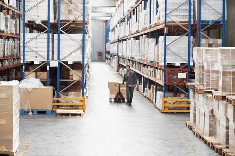 Man, storage and boxes on pallet jack for logistics, inventory management or Stock Photos