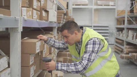 Man store worker using bar code scanner scanning labels on boxes Stock-Fotos
