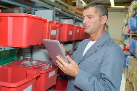 Man in stores using tablet Stock Photos