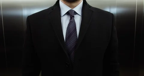 Man straightens his tie in elevator Stock-Footage 86512182