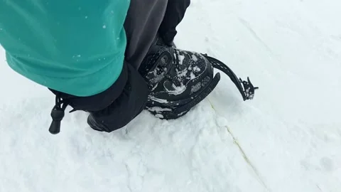 Man strap in snowboard. winter vacation activities Stock Footage 164723516