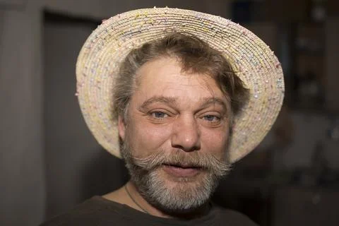 Man in straw hat and beard smiles, pleased with fashion accessory Stock Photos