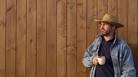 A man in a straw hat drinks tea 4K Video stock 291247301