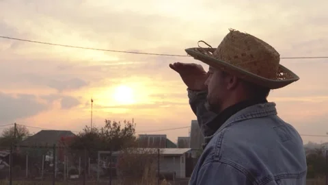 A man in a straw hat looks into the distance 4K Stock Footage 291268992