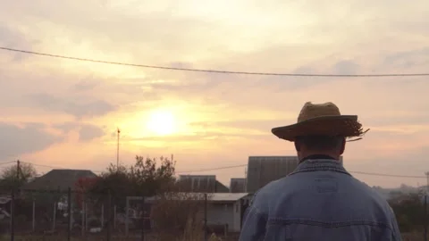 A man in a straw hat walks away into the distance 4K Stock Footage 291268994