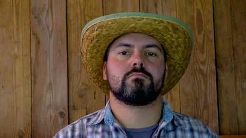 Man in straw hat on wooden background 4K Video stock 95923896