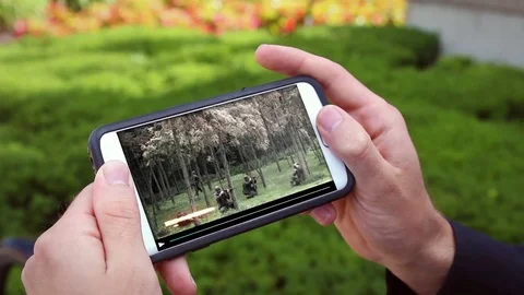 Man streaming an action movie over his smartphone through Wifi Stock Footage 78200215