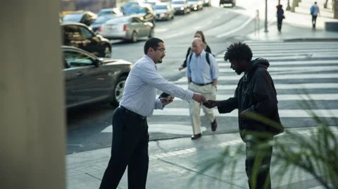 Man on street - helping homeless Stock Footage