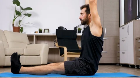 Man stretches and does different yoga poses Stock Footage 95628856