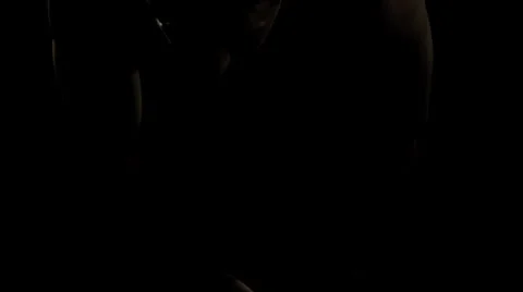Man stretches his back in the dark Stock Footage 33831164