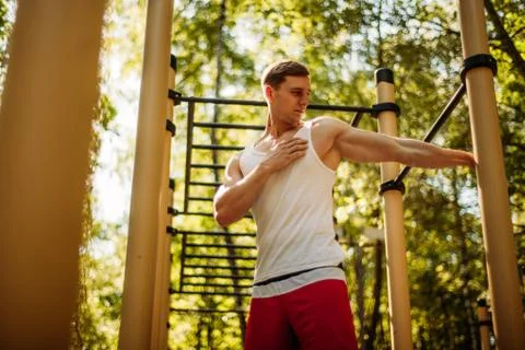 The man stretches the muscles before exercise. Stock Photos
